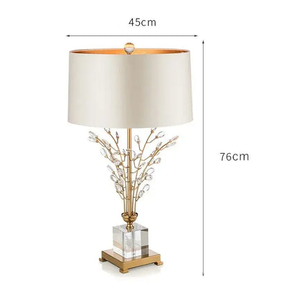 Elegant gold-toned decorbites crystal branch table lamp with cream fabric shade and clear acrylic base for bedroom decor