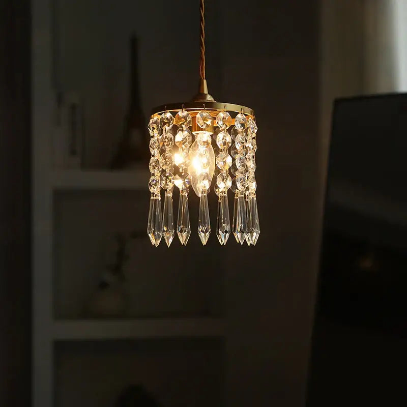 A delicate gold-toned modern crystal brass led pendant light with cascading droplets for dining room decorbites