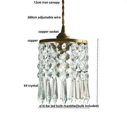 A modern clear faceted k9 crystal brass led pendant light with a brass finished copper canopy and adjustable wire