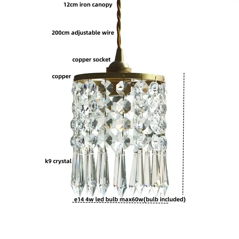A modern clear faceted k9 crystal brass led pendant light with a brass finished copper canopy and adjustable wire