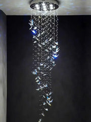 A modern crystal butterfly pendant light with clear crystals pendant strands hanging from a circular ceiling mount