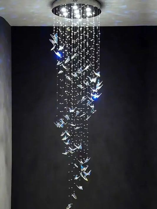 A modern crystal butterfly pendant light with clear crystals pendant strands hanging from a circular ceiling mount