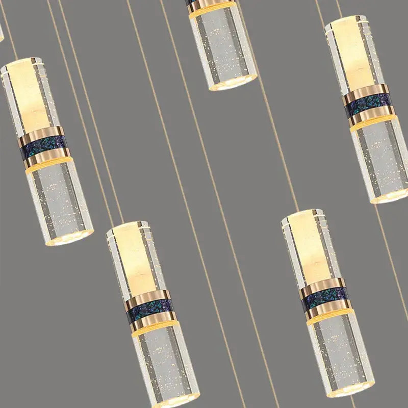 Modern crystal columnar chandelier stair lamp with clear glass and gold metal bands featuring warm interior light