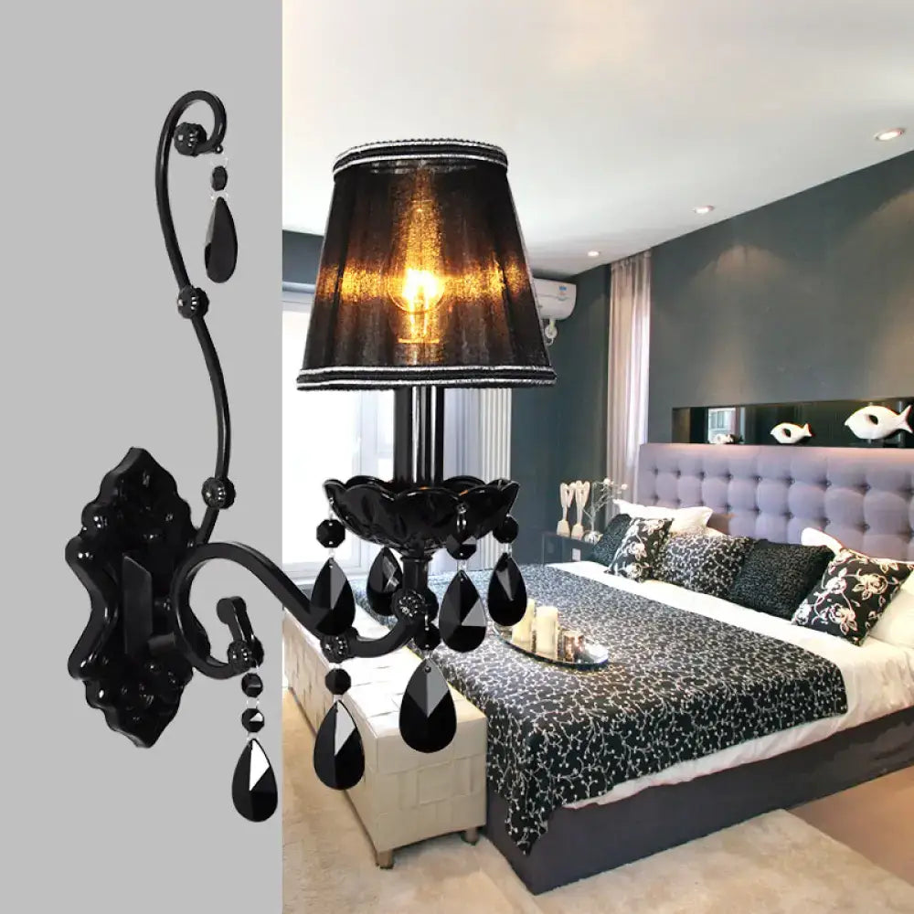 Modern crystal cone wall mount sconce in black wrought iron with dangling crystal teardrop and textured lampshade for living room