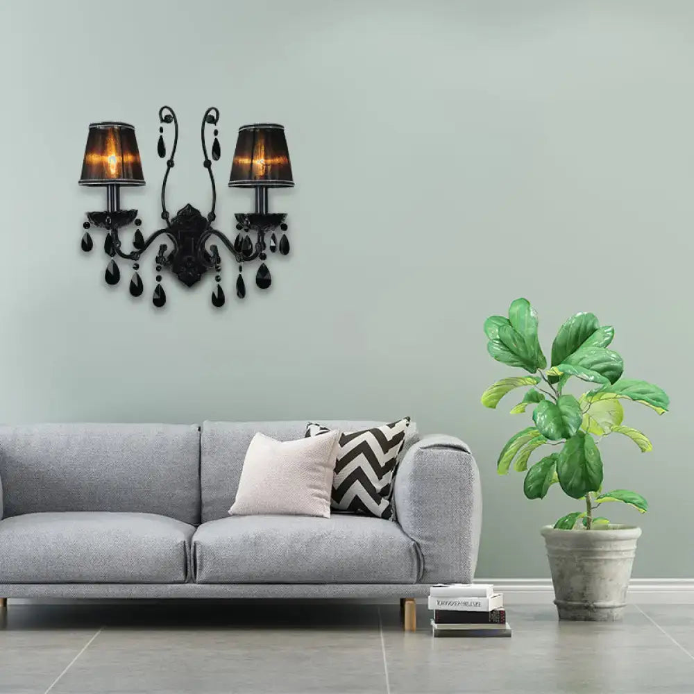 Modern black cone wall mount sconce with amber glass shades and crystal teardrop accents for living room use