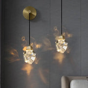 Two modern crystal copper led wall lamps with gold-toned fixtures and black cords illuminate bedroom and stairs decor