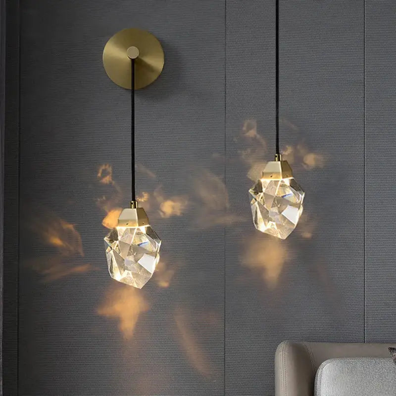 Two modern crystal copper led wall lamps with gold-toned fixtures and black cords illuminate bedroom and stairs decor