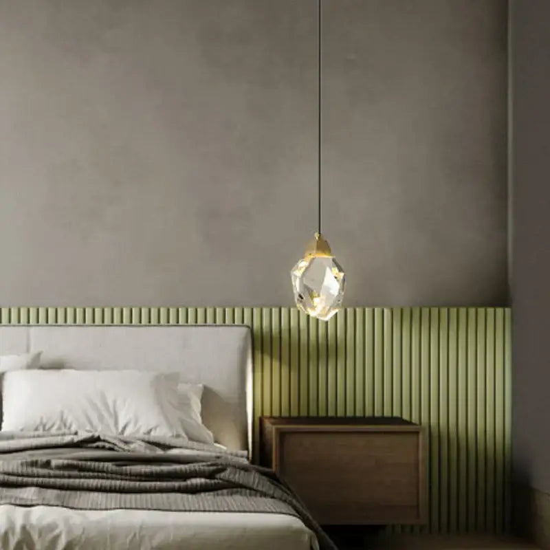 A faceted crystal pendant light with gold-toned metal top and black cord for decorbites crystal copper led wall use