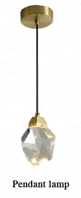 A modern crystal copper led pendant lamp with faceted globe hanging from black cord and gold ceiling plate for decorbites copper led wall accent lighting