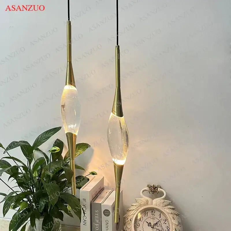 Modern crystal copper wall sconce with gold-toned teardrop glass shades emitting warm led light for dining room decorbites crystal copper wall