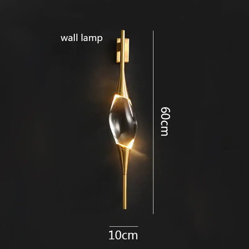 Gold-toned decorbites crystal copper wall sconce with clear teardrop centerpiece and sleek metallic arms for dining room lighting