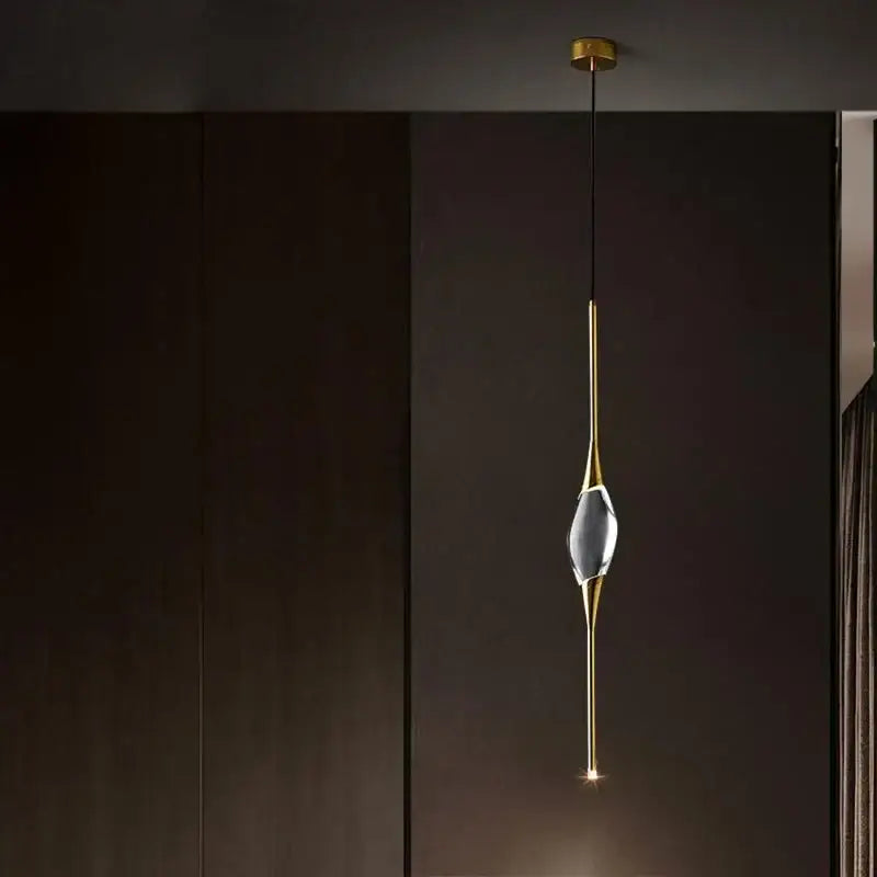 A modern crystal copper wall sconce with a gold-toned metal frame and clear faceted crystal centerpiece for dining room decorbites