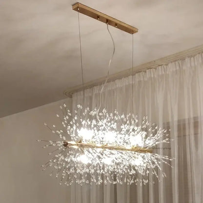 A modern gold-toned decorbites dandelion chandelier led pendant lamp with clear crystal strands for dining room decor