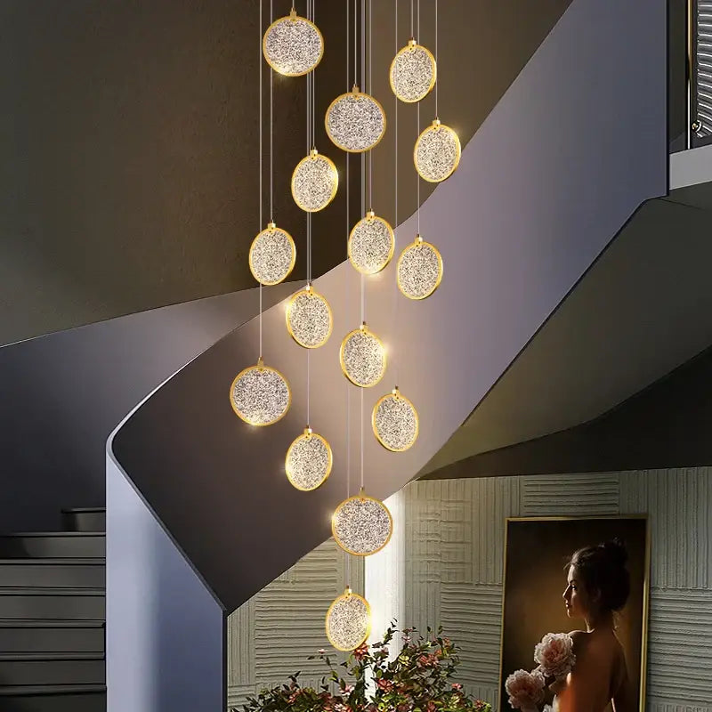 A modern crystal double story led ring chandelier with cascading spherical light fixtures for living room lighting