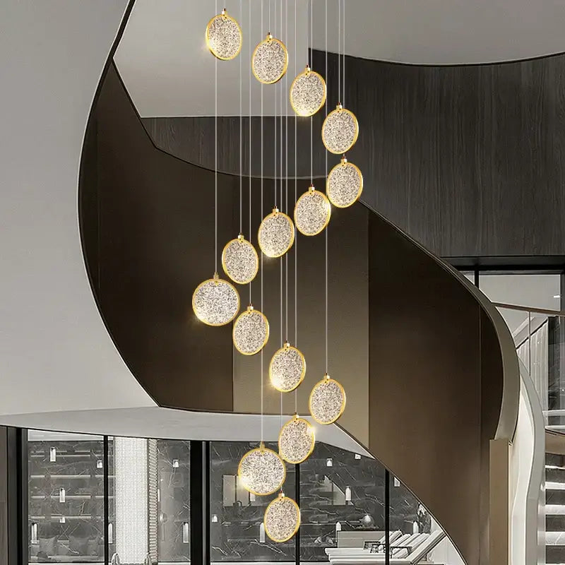 A modern double story led ring chandelier with gold-toned frames and crystal accents for living room lighting