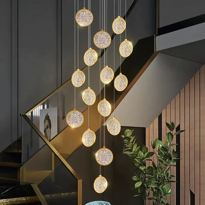 A modern crystal double story led ring chandelier with golden frames and sparkling crystal interiors for living room