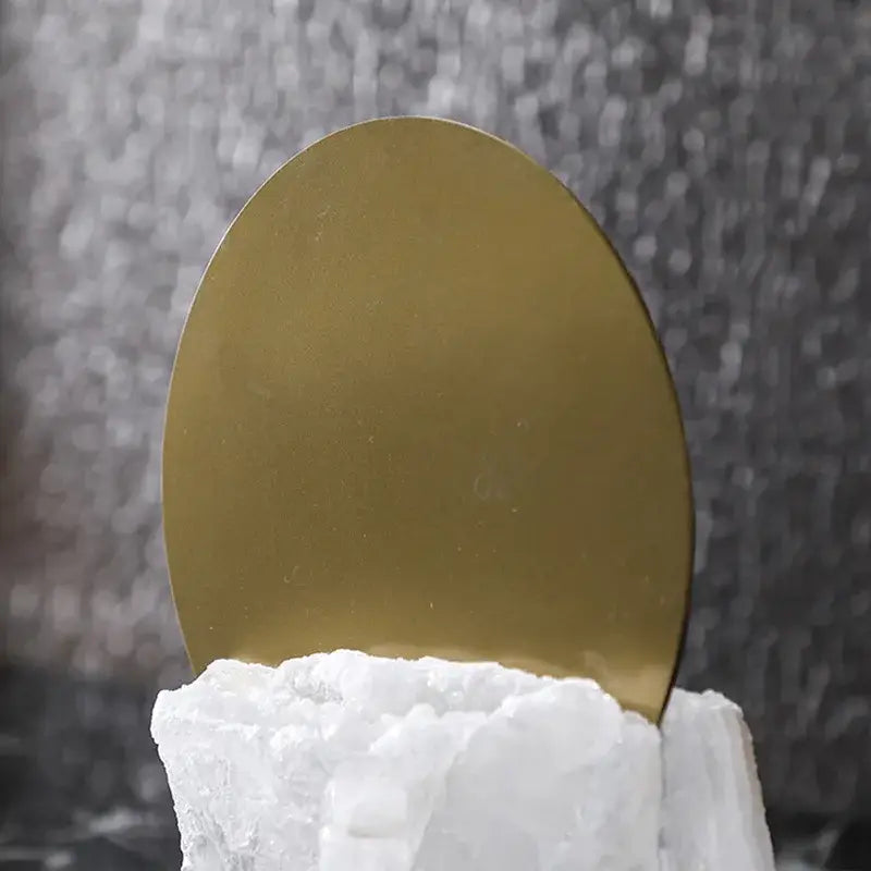 Modern crystal geometric metal sculpture bookends featuring a gold-plated disc on a white crystalline base for living room decorbites crystal geometric