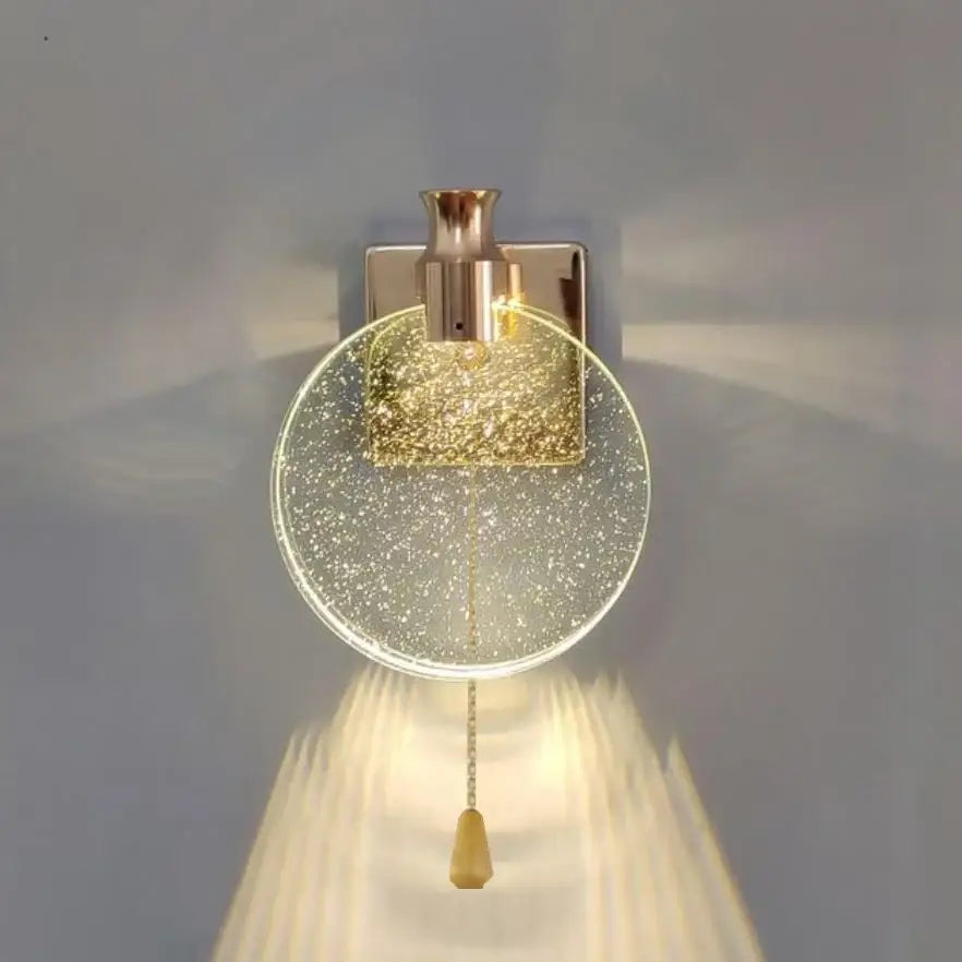 Modern wall lamp with decorbites crystal glass gold circular shade and brushed brass finish for bedroom sconce decor