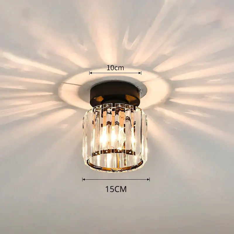 A modern crystal glass nordic LED chandelier with black base and clear vertical prisms for dining room decorbites decor