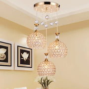 Modern crystal gold ceiling chandelier featuring three spherical crystal pendant lights with gold metal fixtures decorbites crystal gold