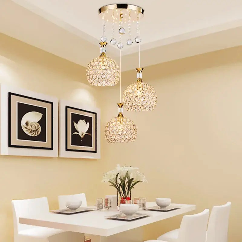 Modern crystal gold ceiling chandelier with three-globe design, gold-toned metal, and dangling clear beads for luxury decorbites decorbites crystal gold