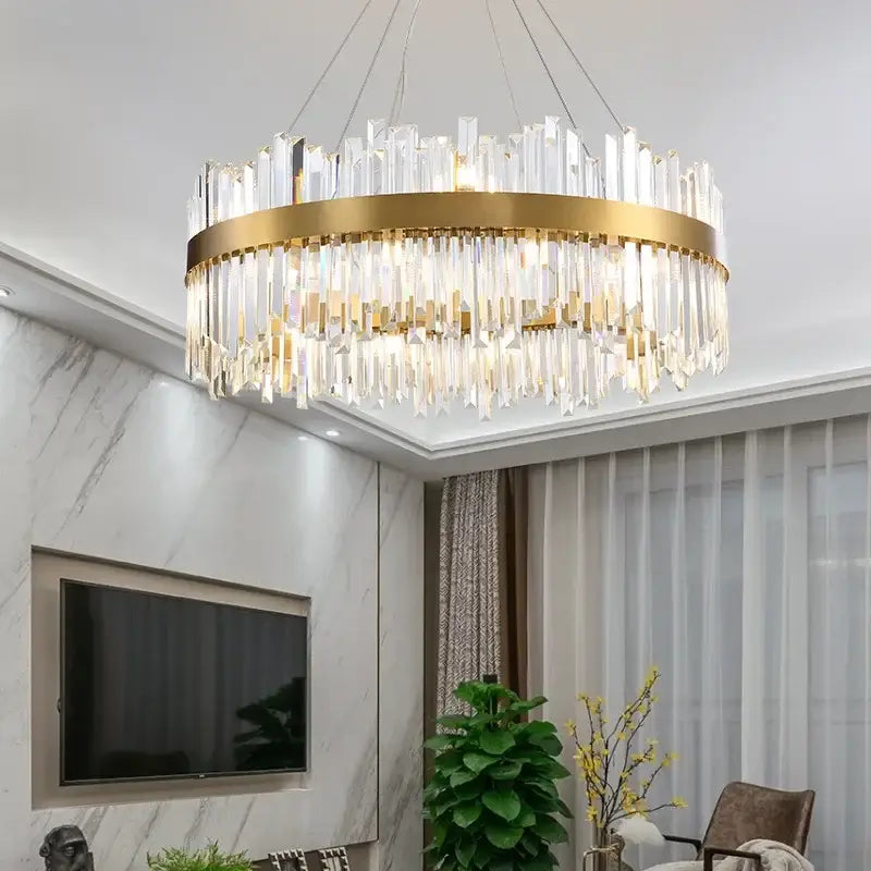 A modern pendant light with a gold-toned metal frame and cascading clear crystal prisms for dining room decorbites crystal gold ceiling