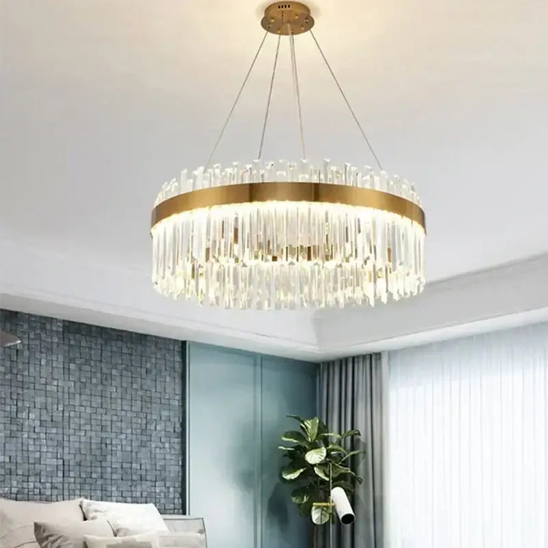A modern pendant light with a gold-toned metal frame and cascading crystal prisms for decorbites crystal gold ceiling decor