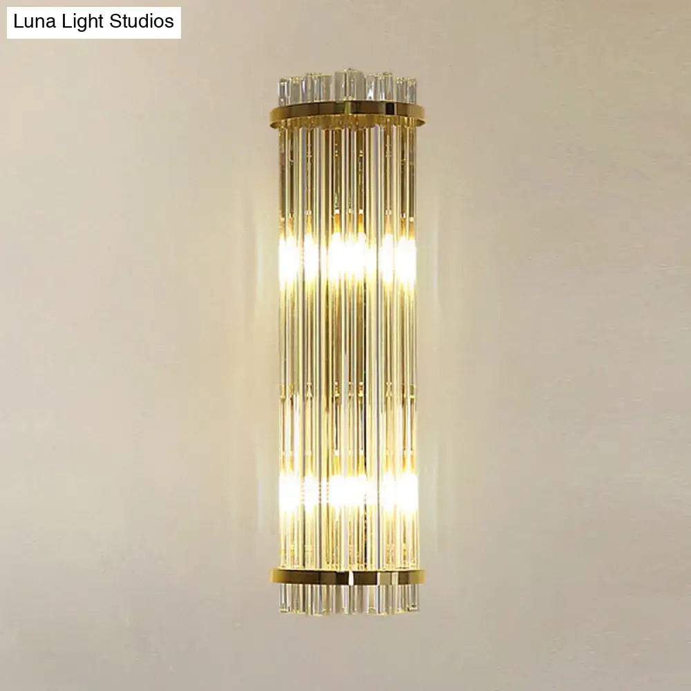 Gold finish modern wall lighting with vertical crystal rods designed as a sleek bedroom sconce in gold finish