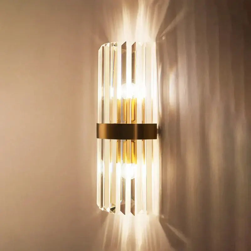 Modern wall lamp with vertical crystal gold led rods and brushed brass band from decorbites crystal gold collection for bedroom lighting