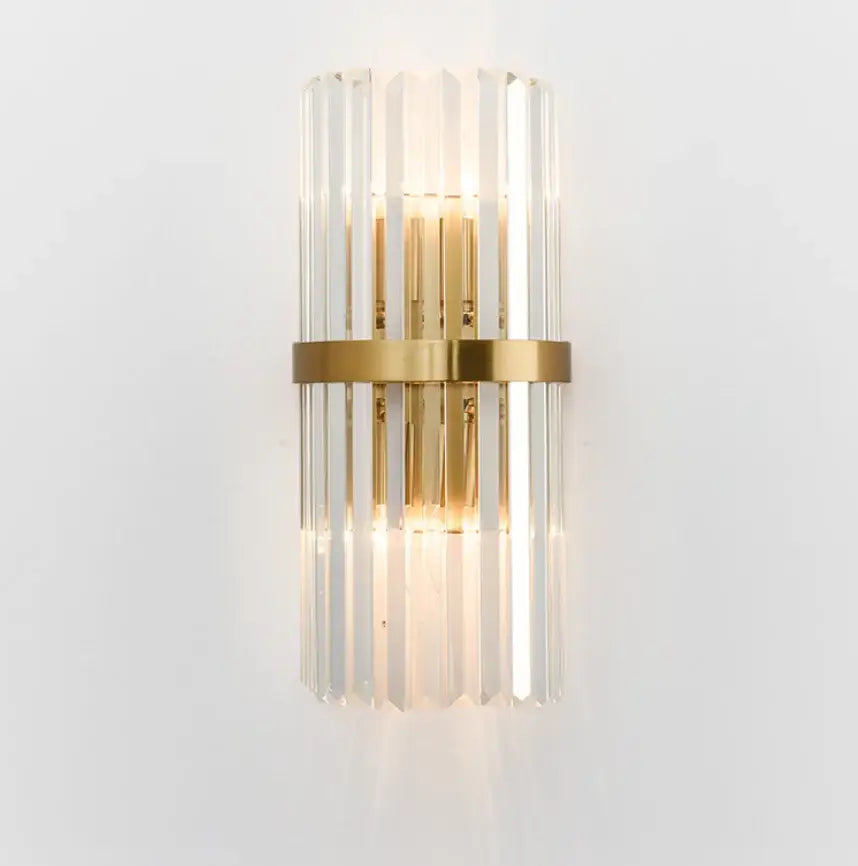Modern crystal gold led wall lamp featuring gold-toned vertical crystal rods and a central brass band for elegant bedroom lighting decorbites crystal gold wall lamp