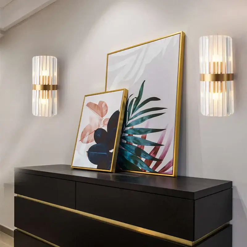Gold-framed botanical artwork with abstract teal pink and black motifs complements modern crystal gold led wall sconce decorbites