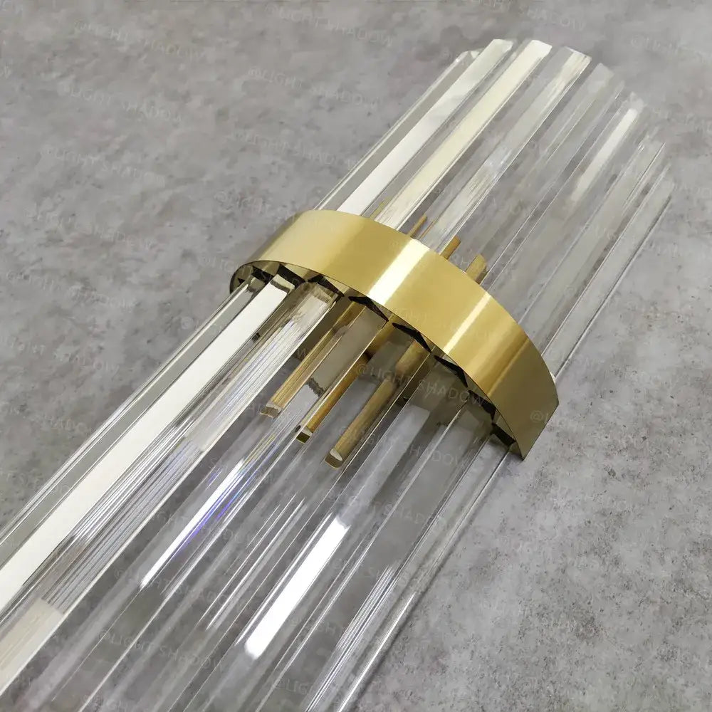 Modern crystal gold led wall sconce featuring clear glass prism rods and a polished gold-toned metal band decorbites crystal gold