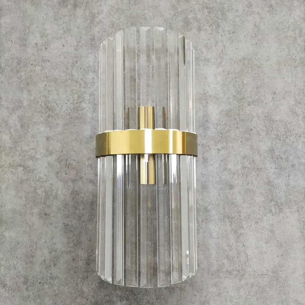 Modern crystal gold led wall sconce featuring clear glass vertical fluted rods and polished gold-toned metal band decorbites crystal gold