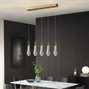 Modern crystal gold pendant lights featuring a gold-toned rectangular fixture with five teardrop glass pendants for dining room decorbites crystal gold pendant