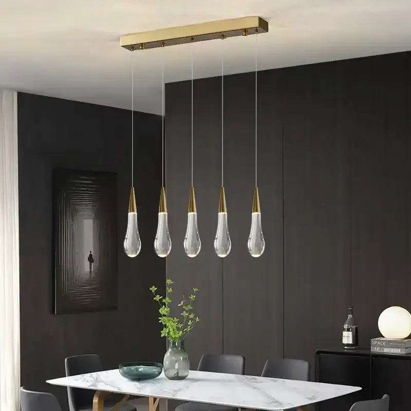 Modern crystal gold pendant lights featuring a gold-toned rectangular fixture with five teardrop glass pendants for dining room decorbites crystal gold pendant