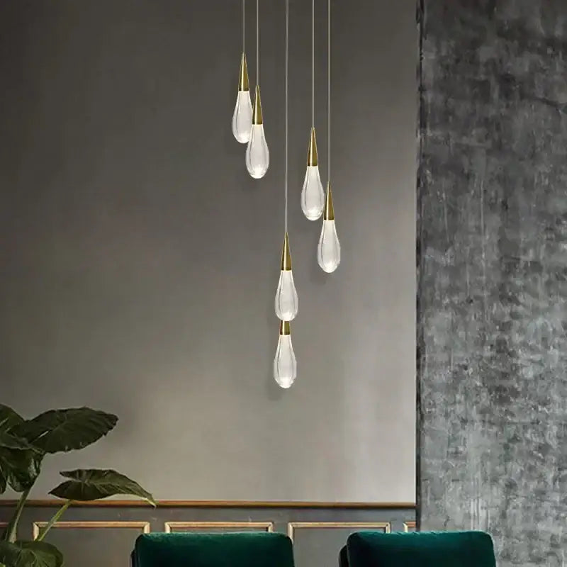 Modern crystal gold pendant lights with clear teardrop glass shades and gold-toned metal tops for dining room decorbites crystal gold pendant