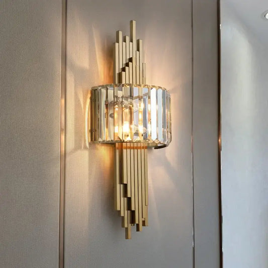 Modern crystal gold wall lamp with gold-toned vertical crystal bars and a cylindrical glass shade for bedroom decorbites crystal gold decor