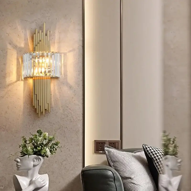 Modern crystal gold wall lamp featuring gold-toned sconce with vertical crystal bars and illuminated glass shade decorbites crystal gold