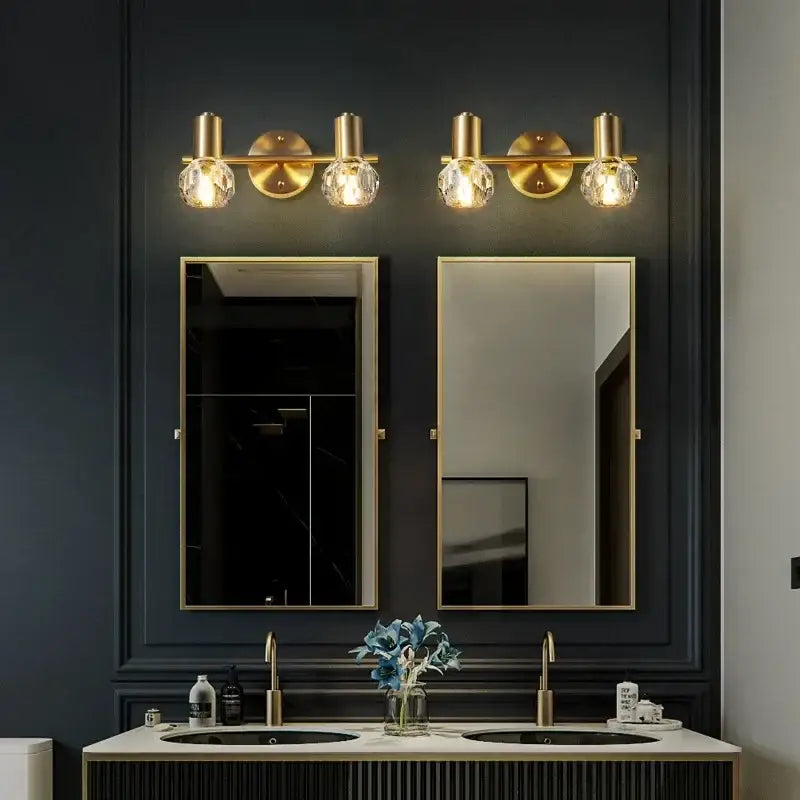 Modern crystal gold wall lamp with three globe crystal bulbs in gold-toned decorbites crystal gold wall fixture