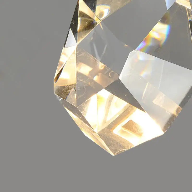 A faceted transparent crystal golden wall sconce pendant with geometric design and warm glass lighting decorbites crystal golden