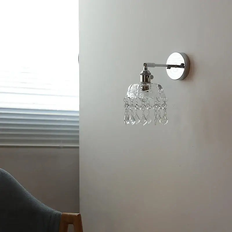 A modern crystal iron led wall light bedroom sconce with polished chrome finish and dangling faceted glass beads decorbites crystal iron