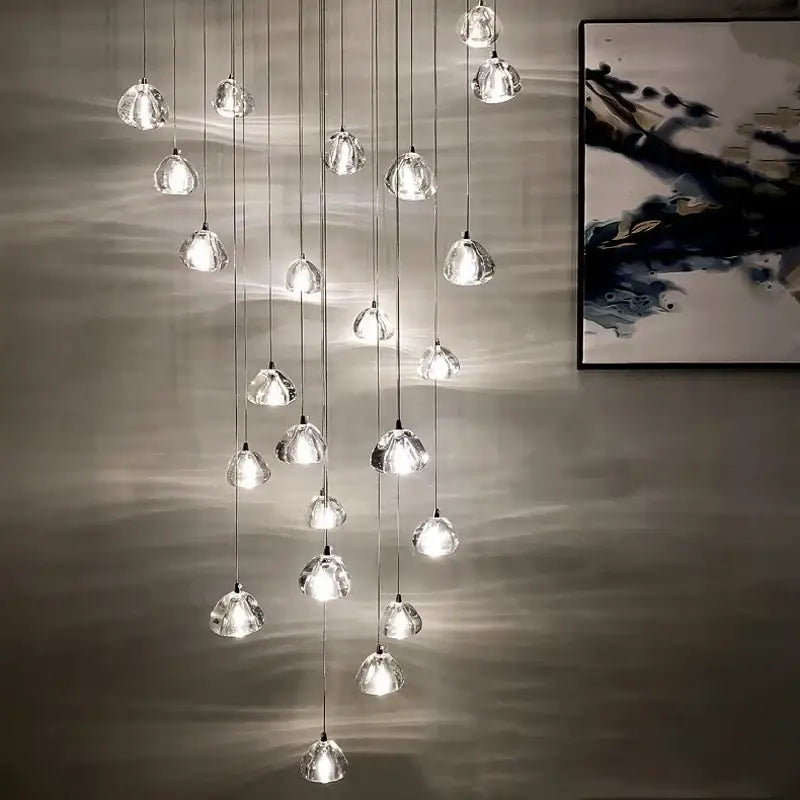 A modern decorbites crystal led ceiling chandelier with glass globe pendants suspended by thin metallic cords