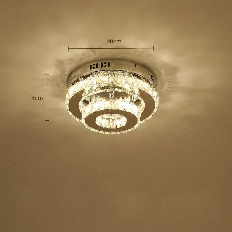 A modern crystal led ceiling lamp with circular tiers of clear faceted crystals and polished chrome metal for living room decorbites crystal led