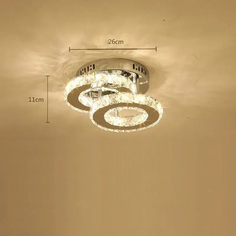 Modern chrome-finished decorbites crystal led ceiling lamp with three interlocking rings emitting warm light for living room decor