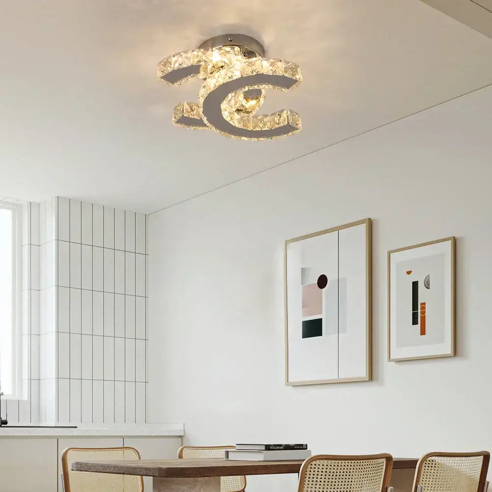 Modern crystal led ceiling lamp with sleek interlocking cc logo design in clear crystal and metallic accents for living room decorbites crystal led