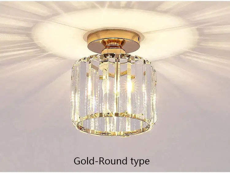 Gold-toned decorbites crystal led ceiling light with vertical crystal prisms and polished brass base for modern kitchen decor