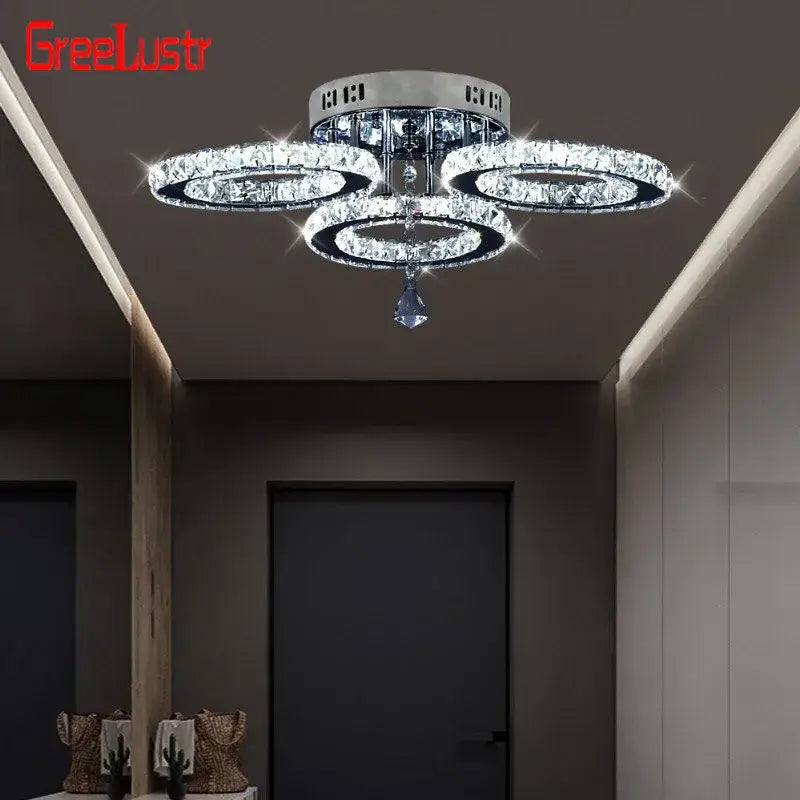 Shiny chrome finished modern crystal led ceiling light with three interlocking rings and a faceted pendant