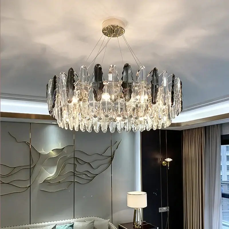 A modern circular decorbites crystal led chandelier with clear and dark glass prisms for dining room lighting