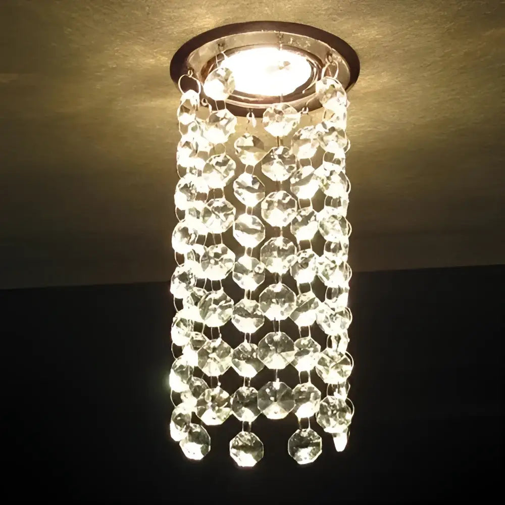 A clear faceted crystal led downlight ceiling lamp with a circular metallic base for modern living room decorbites