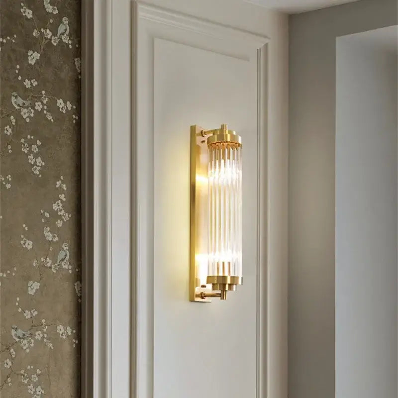 Modern crystal led gold wall sconce with vertical glass rod prisms for elegant bedroom lighting decorbites crystal led design